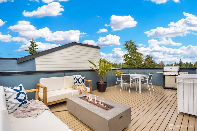 wooden deck with outdoor dining space, grilling area, and an outdoor living space with a fire pit