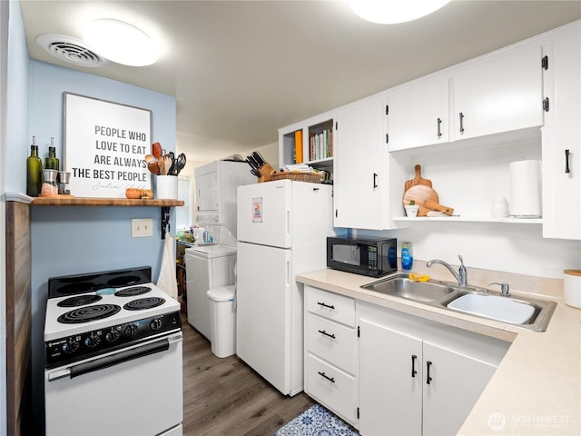 kitchen with white appliances, visible vents, white cabinetry, open shelves, and a sink