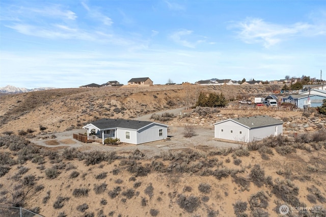 birds eye view of property with view of desert and a mountain view