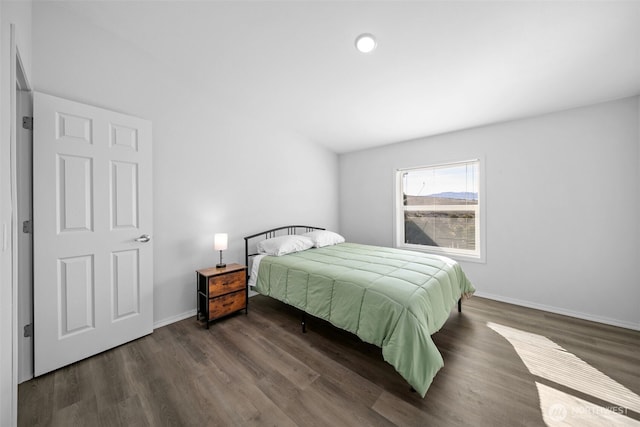 bedroom featuring baseboards and wood finished floors