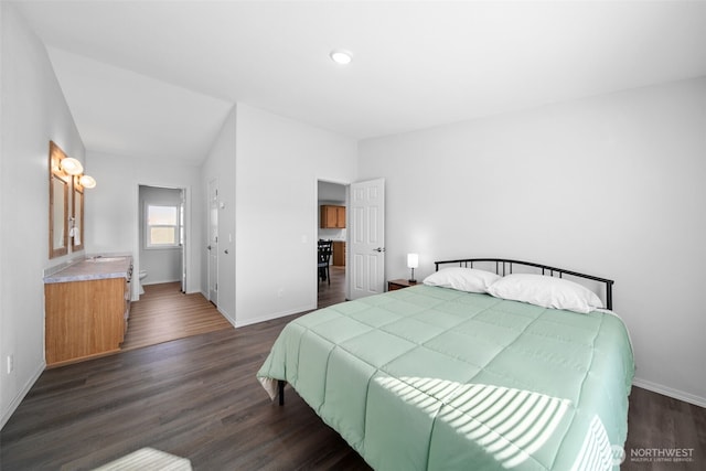 bedroom featuring dark wood-type flooring and baseboards