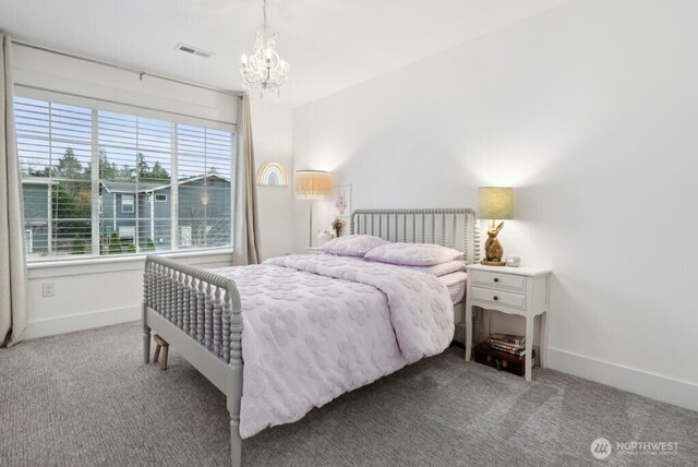 bedroom featuring baseboards, visible vents, a chandelier, and carpet flooring