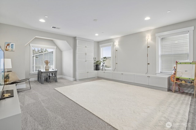 living room featuring baseboards, recessed lighting, visible vents, and light colored carpet