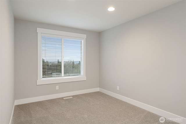 carpeted spare room with recessed lighting, visible vents, and baseboards