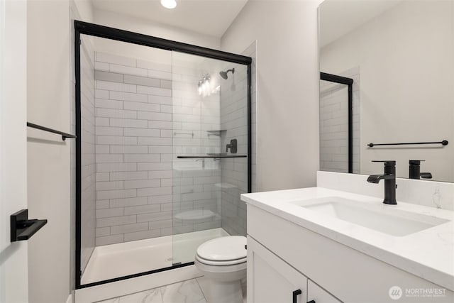 bathroom with vanity, toilet, marble finish floor, and a shower stall