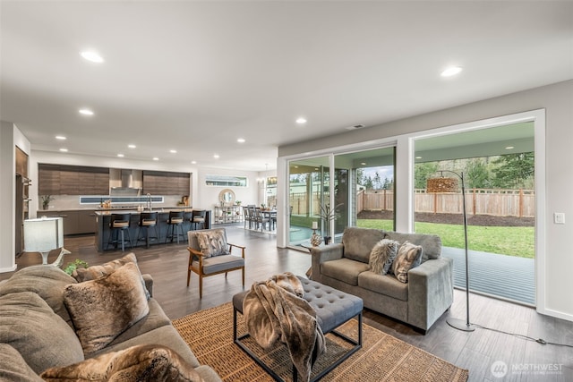 living room featuring recessed lighting and dark wood-type flooring