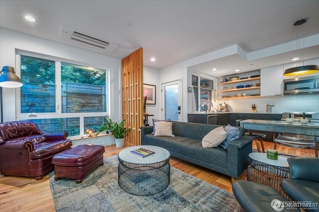 living room with recessed lighting and light wood finished floors