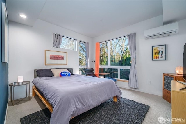 bedroom featuring a wall unit AC, carpet flooring, and baseboards