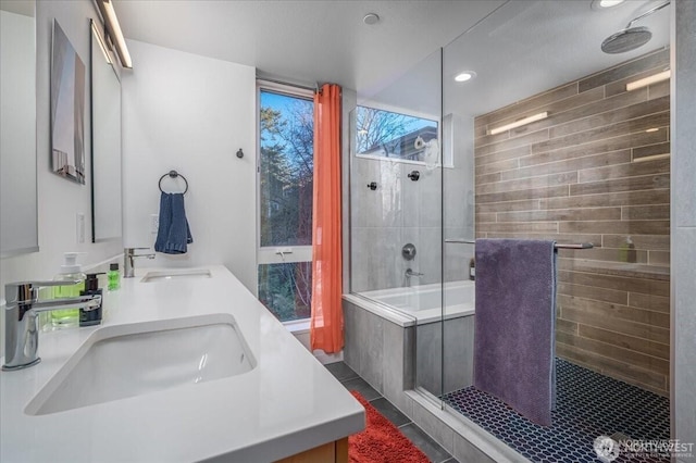 full bath featuring double vanity, tiled shower / bath combo, a sink, and tile patterned floors