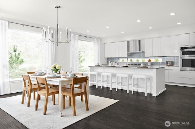 dining space with an inviting chandelier, dark wood-style flooring, and recessed lighting