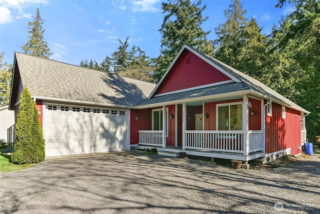 view of front of property with a porch, driveway, a garage, and roof with shingles