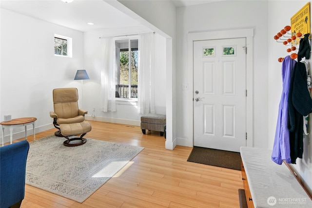 foyer with recessed lighting, baseboards, and light wood-style flooring