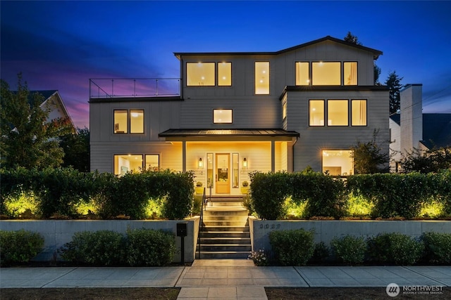 contemporary house with a standing seam roof, metal roof, and board and batten siding