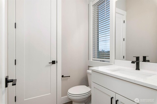 bathroom with toilet and vanity