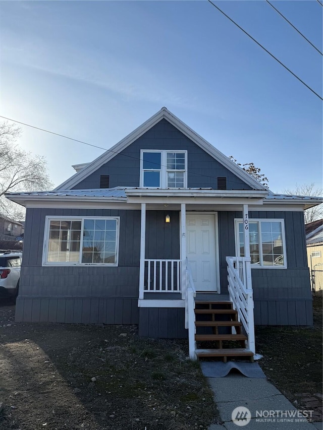 view of front of house featuring metal roof and a porch