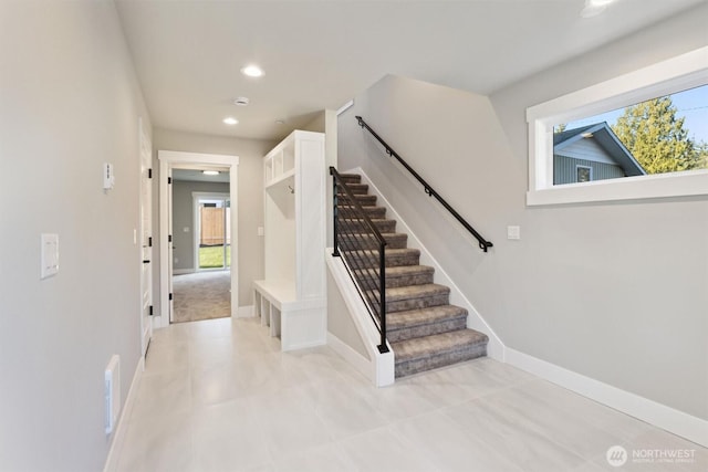 stairs with baseboards and recessed lighting