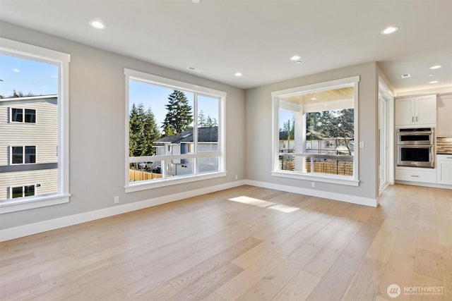 unfurnished living room featuring recessed lighting, baseboards, visible vents, and light wood finished floors