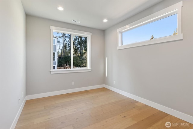 unfurnished room with light wood-type flooring, baseboards, and recessed lighting