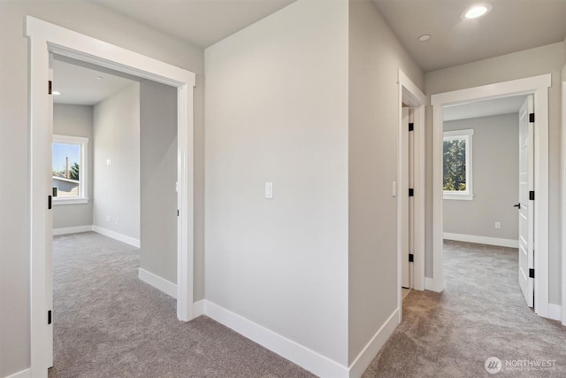 corridor featuring baseboards, carpet flooring, and recessed lighting