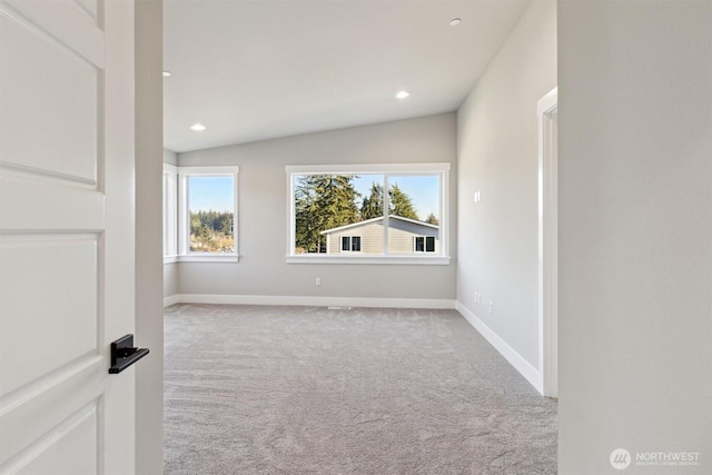 carpeted spare room with baseboards, vaulted ceiling, a wealth of natural light, and recessed lighting