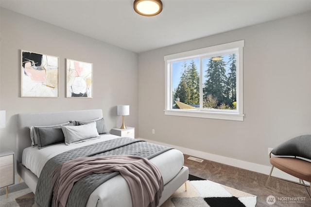 carpeted bedroom with visible vents and baseboards