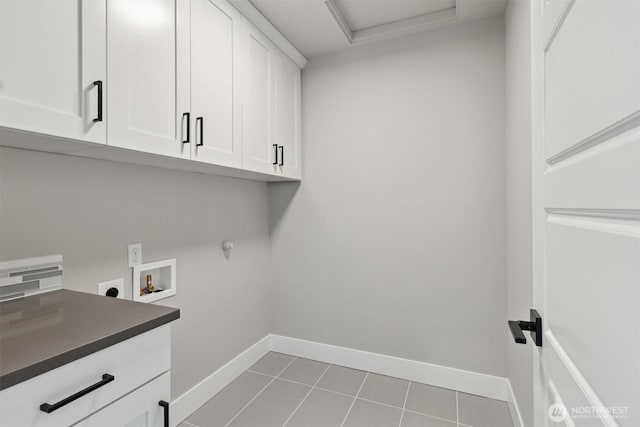 laundry room featuring hookup for a washing machine, baseboards, cabinet space, tile patterned floors, and electric dryer hookup