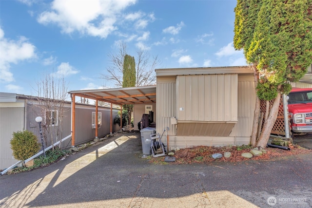 view of front of property featuring a carport and aphalt driveway