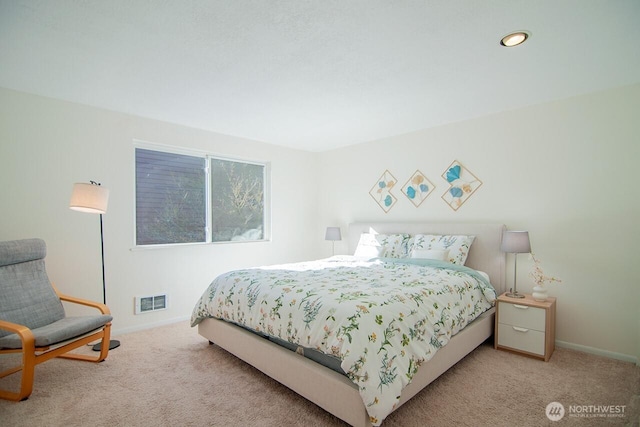 carpeted bedroom with visible vents and baseboards