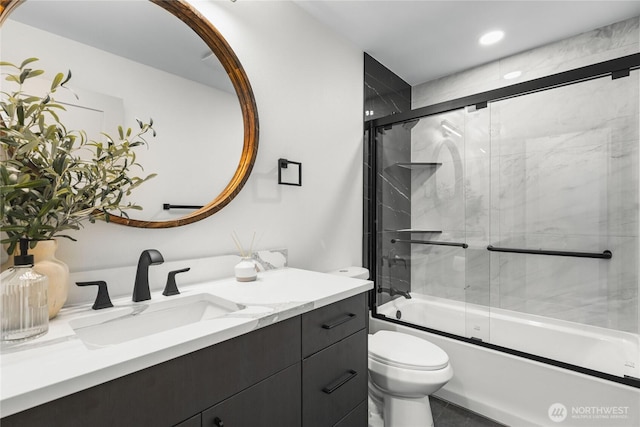 full bathroom featuring toilet, recessed lighting, combined bath / shower with glass door, and vanity