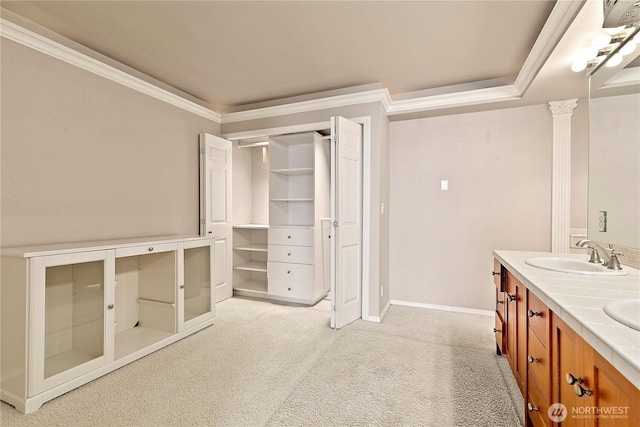 bathroom with double vanity, carpet flooring, ornamental molding, and a sink