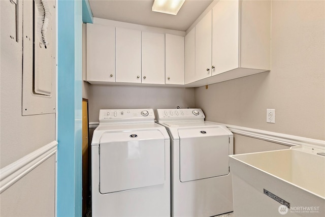 laundry area featuring a sink, cabinet space, and washer and dryer