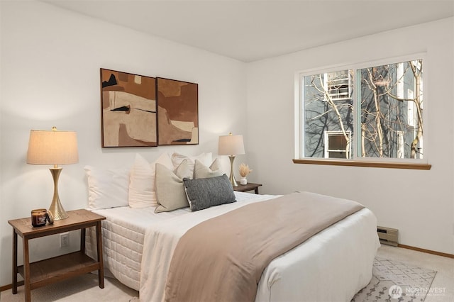 carpeted bedroom featuring baseboards and a baseboard heating unit