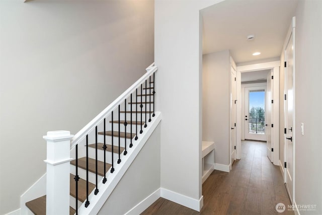 staircase featuring recessed lighting, baseboards, and wood finished floors