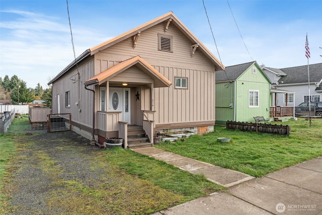 view of front of house featuring a front lawn and board and batten siding