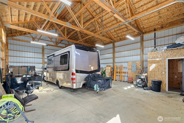 garage featuring electric panel and metal wall