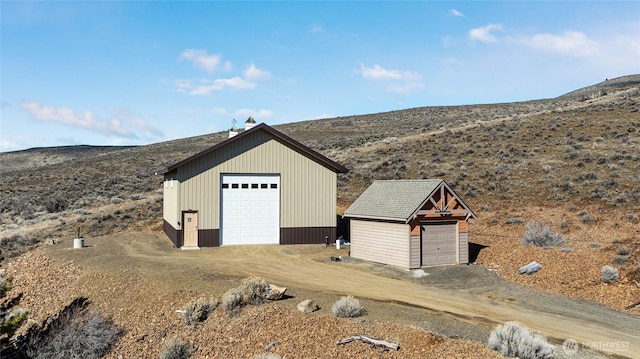 detached garage featuring a mountain view