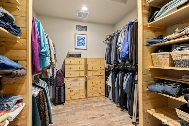 walk in closet with wood finished floors and visible vents