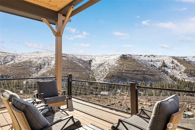 wooden deck featuring a mountain view