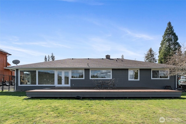 back of property with a lawn and a wooden deck