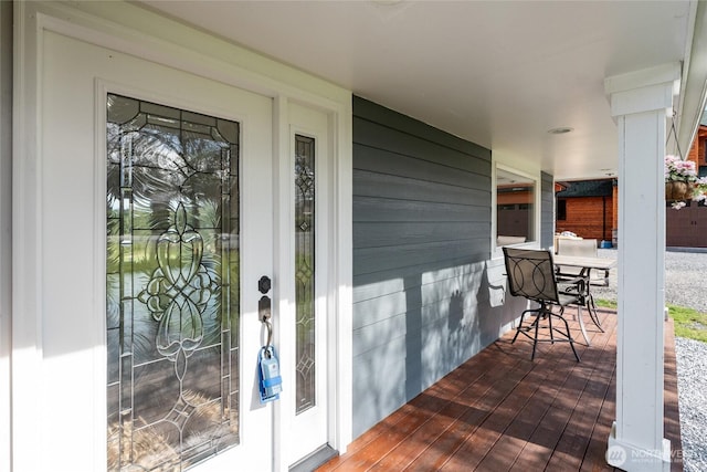 view of exterior entry with covered porch