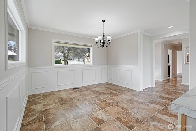 unfurnished dining area with ornamental molding, visible vents, plenty of natural light, and an inviting chandelier