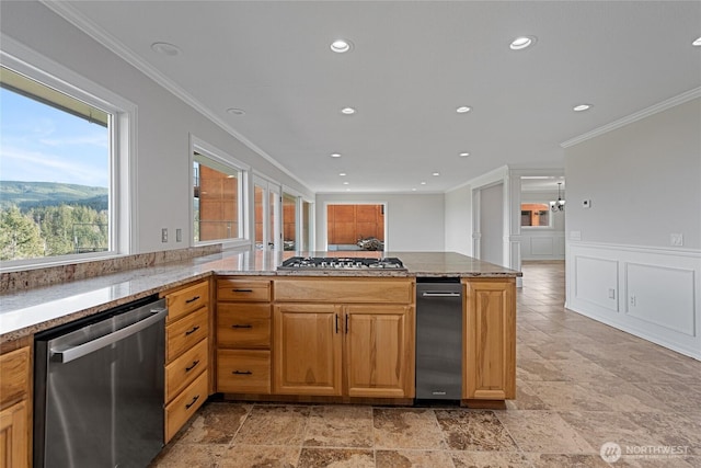 kitchen featuring ornamental molding, appliances with stainless steel finishes, light stone counters, and recessed lighting