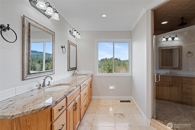 bathroom featuring a sink, visible vents, and crown molding