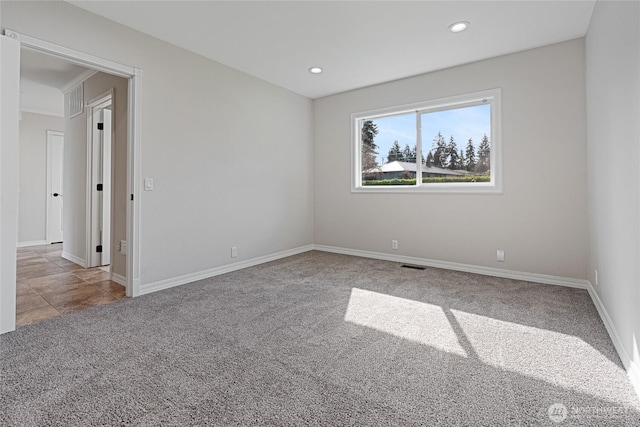 unfurnished room featuring carpet floors, baseboards, visible vents, and recessed lighting