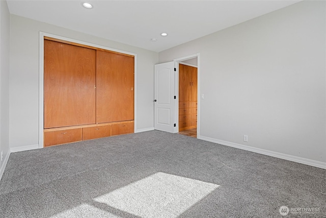 unfurnished bedroom featuring recessed lighting, a closet, carpet, and baseboards