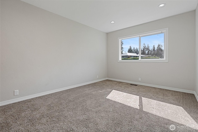 carpeted empty room with baseboards, visible vents, and recessed lighting