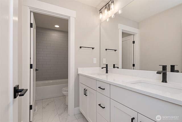 full bathroom featuring marble finish floor, a sink, toilet, and double vanity