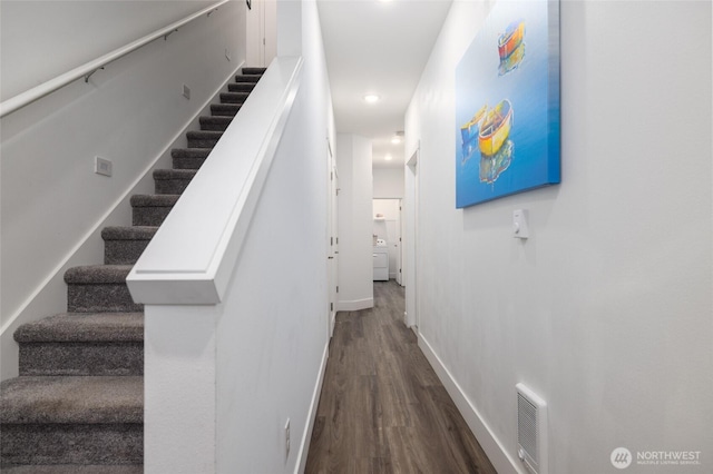 stairs with baseboards, visible vents, and wood finished floors