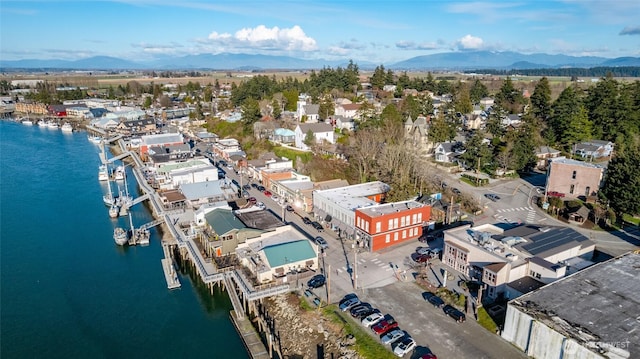 aerial view featuring a water and mountain view