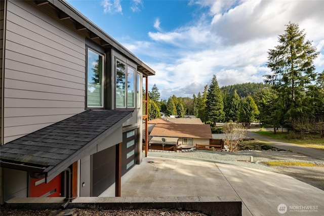 view of home's exterior with a shingled roof